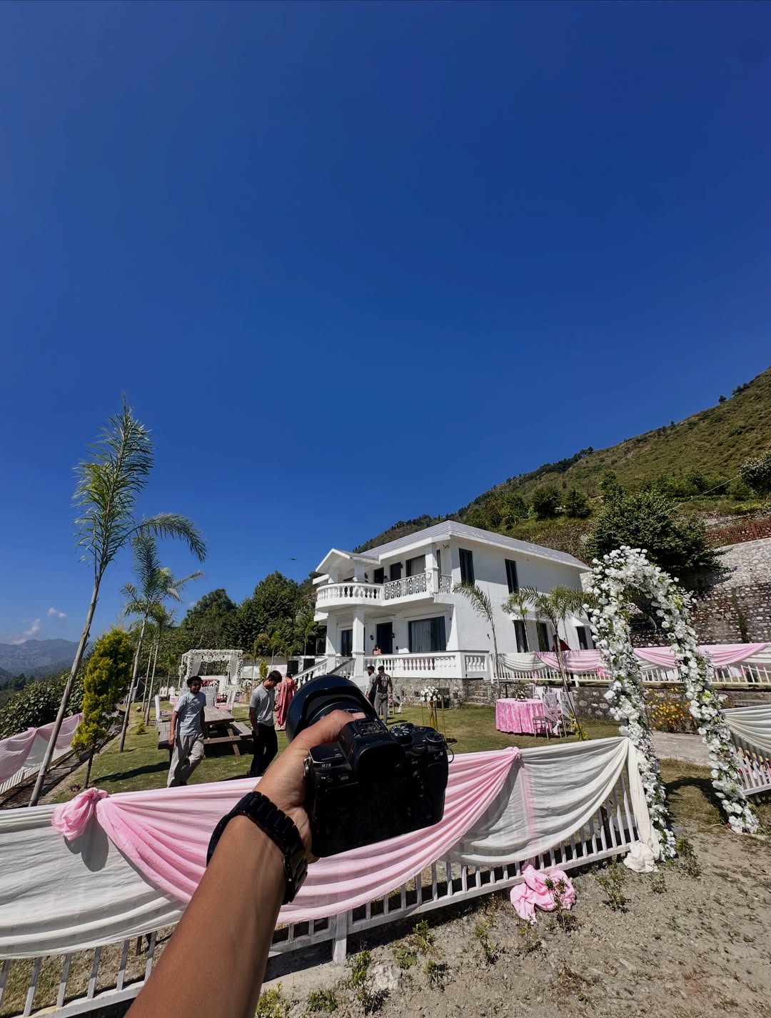 Nitin's point of view: a camera in hand at a decorated celebration venue in Bhimtal
